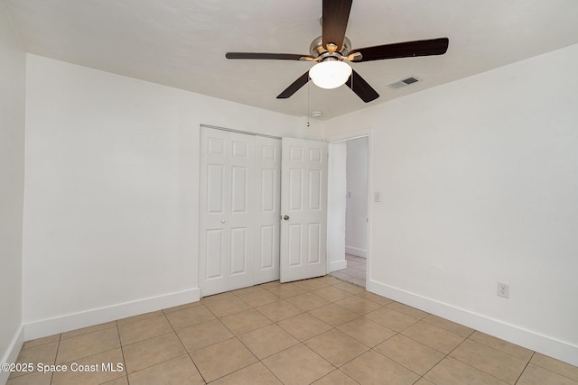2515 Andrews Ave, Melbourne, FL 32935 - unfurnished bedroom featuring light tile patterned floors, a closet, and ceiling fan