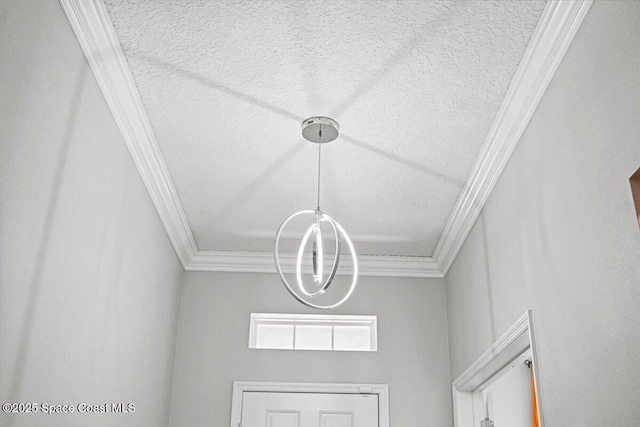 922 Raleigh Rd SE, Palm Bay, FL 32909 - detailed view of ornamental molding, a textured ceiling, and a chandelier
