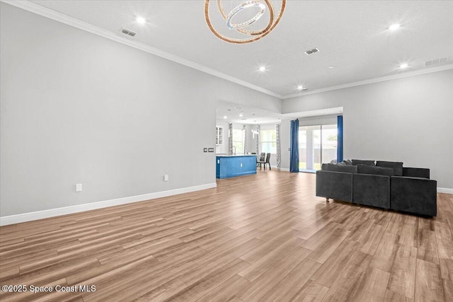 922 Raleigh Rd SE, Palm Bay, FL 32909 - unfurnished living room featuring recessed lighting, light wood finished floors, ornamental molding, and a chandelier