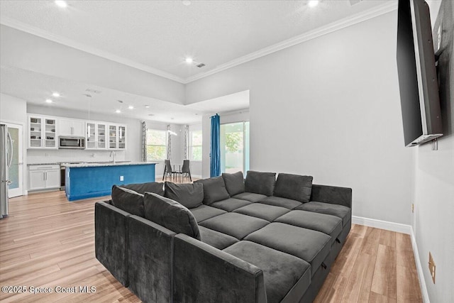 922 Raleigh Rd SE, Palm Bay, FL 32909 - living area with light wood-type flooring, recessed lighting, and ornamental molding