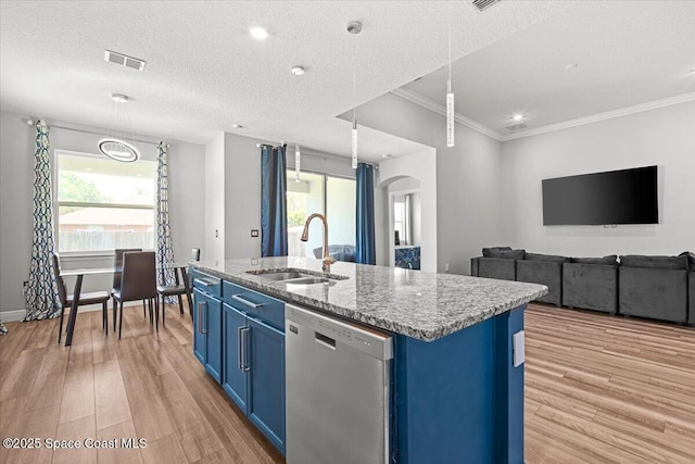 922 Raleigh Rd SE, Palm Bay, FL 32909 - kitchen with dishwasher, blue cabinets, light wood finished floors, a center island with sink, and healthy amount of natural light
