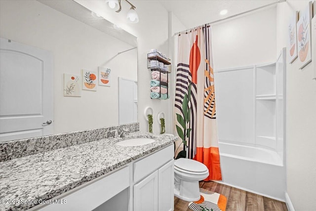 922 Raleigh Rd SE, Palm Bay, FL 32909 - bathroom featuring wood finished floors, vanity, and shower / bathtub combination with curtain