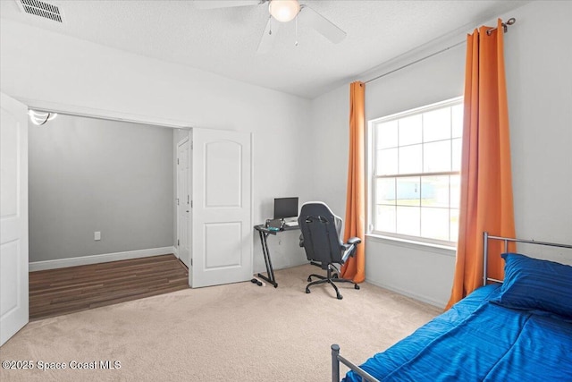 922 Raleigh Rd SE, Palm Bay, FL 32909 - carpeted bedroom with a desk, a ceiling fan, and a textured ceiling