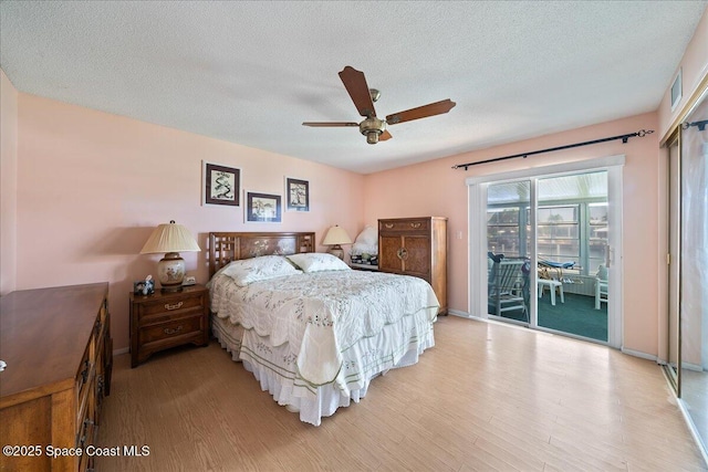443 Aruba Ct, Satellite Beach, FL 32937 - bedroom with access to exterior, light wood finished floors, a textured ceiling, and a ceiling fan