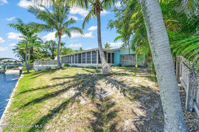 443 Aruba Ct, Satellite Beach, FL 32937 - view of yard with a sunroom, a boat dock, and a water view