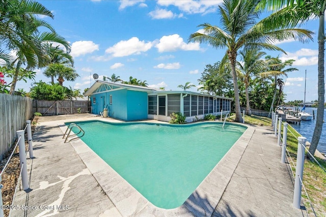 443 Aruba Ct, Satellite Beach, FL 32937 - view of swimming pool with a sunroom, a fenced backyard, and a patio
