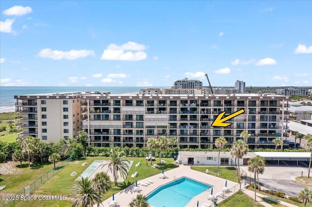 3170 N Atlantic Ave Unit 412, Cocoa Beach, FL 32931 - view of apartment building / complex with a water view and a community pool