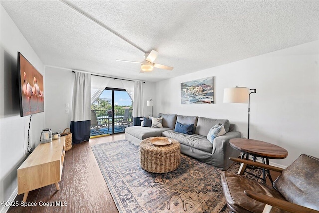 3170 N Atlantic Ave Unit 412, Cocoa Beach, FL 32931 - living room with wood finished floors, a ceiling fan, and a textured ceiling