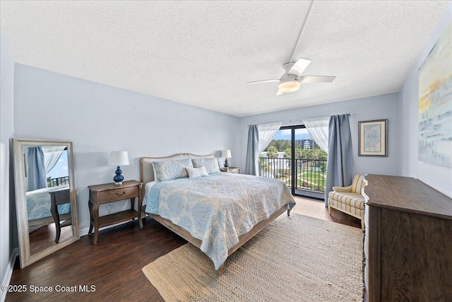 3170 N Atlantic Ave Unit 412, Cocoa Beach, FL 32931 - bedroom with access to outside, dark wood-style floors, a textured ceiling, and a ceiling fan