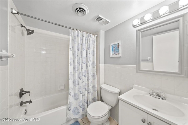 3170 N Atlantic Ave Unit 412, Cocoa Beach, FL 32931 - full bath featuring shower / bath combination with curtain, vanity, tile walls, and wainscoting