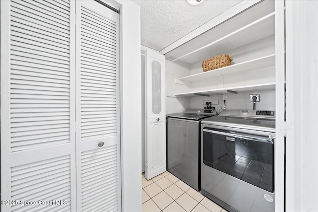 3170 N Atlantic Ave Unit 412, Cocoa Beach, FL 32931 - kitchen featuring washing machine and dryer, open shelves, light tile patterned floors, and a textured ceiling