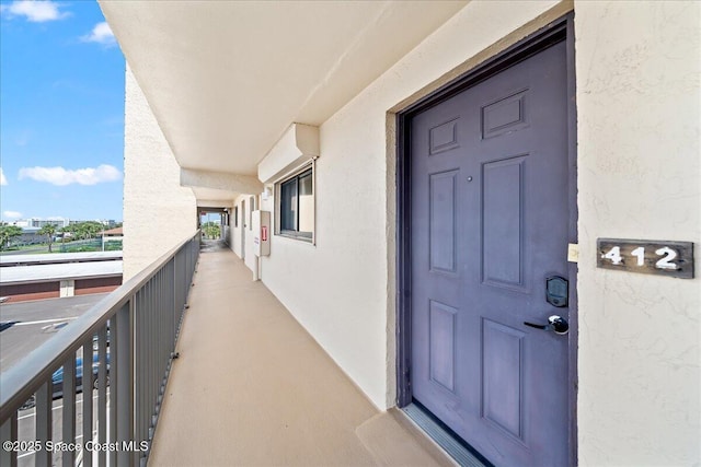 3170 N Atlantic Ave Unit 412, Cocoa Beach, FL 32931 - view of exterior entry featuring stucco siding and a balcony