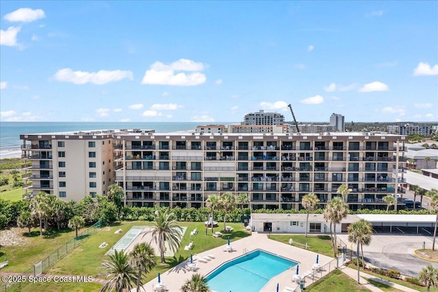 3170 N Atlantic Ave Unit 412, Cocoa Beach, FL 32931 - view of apartment building / complex with a community pool and a water view