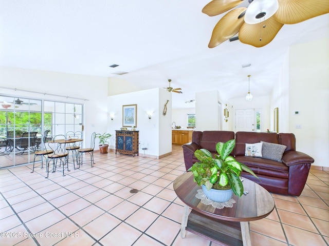 3200 Grant Rd, Grant-Valkaria, FL 32949 - living room featuring lofted ceiling, light tile patterned floors, and a ceiling fan