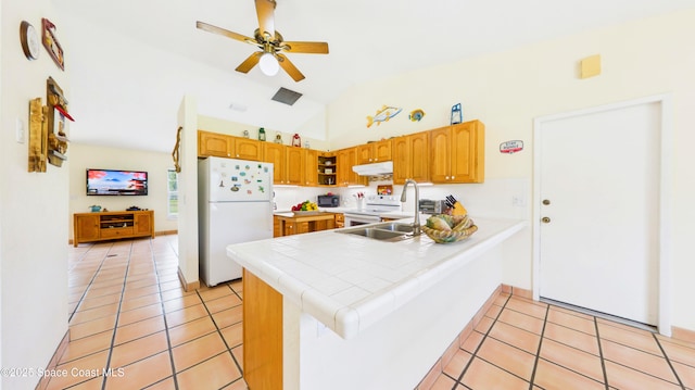 3200 Grant Rd, Grant-Valkaria, FL 32949 - kitchen featuring white appliances, under cabinet range hood, a peninsula, a ceiling fan, and tile countertops