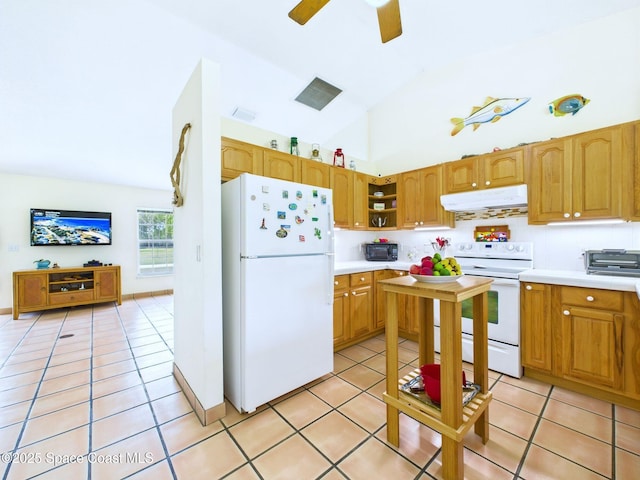 3200 Grant Rd, Grant-Valkaria, FL 32949 - kitchen with white appliances, under cabinet range hood, light tile patterned floors, light countertops, and high vaulted ceiling