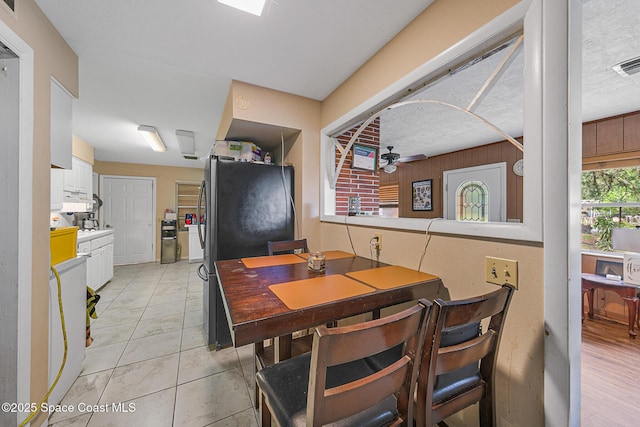 1714 Blanche Ave, Melbourne, FL 32934 - dining space featuring a ceiling fan and wood walls