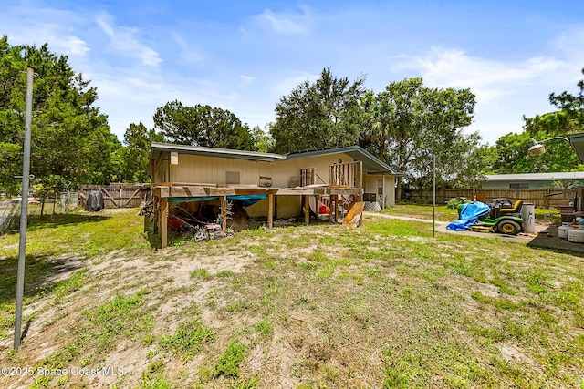 1714 Blanche Ave, Melbourne, FL 32934 - back of property with a fenced backyard and a deck