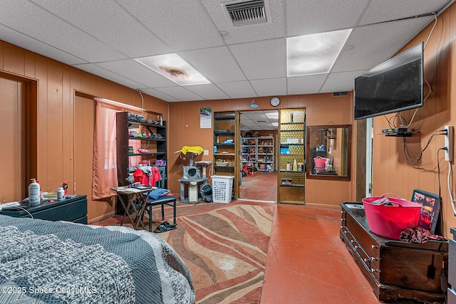 1714 Blanche Ave, Melbourne, FL 32934 - bedroom featuring wood walls, a drop ceiling, and concrete floors