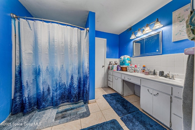 1714 Blanche Ave, Melbourne, FL 32934 - full bath with tile patterned floors, vanity, curtained shower, and tile walls