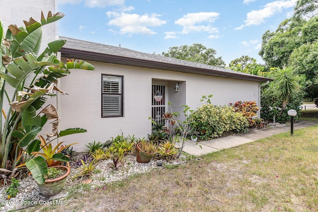 3461 Cove Ct, Melbourne, FL 32935 - view of home's exterior featuring stucco siding and a shingled roof