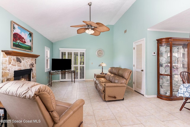 3461 Cove Ct, Melbourne, FL 32935 - living area featuring vaulted ceiling, ceiling fan, a stone fireplace, and light tile patterned flooring