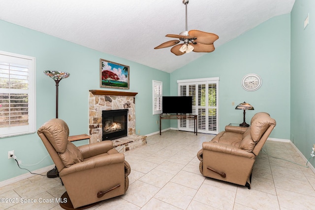 3461 Cove Ct, Melbourne, FL 32935 - living area featuring a ceiling fan, a fireplace, a textured ceiling, light tile patterned floors, and high vaulted ceiling