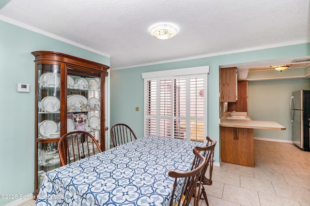 3461 Cove Ct, Melbourne, FL 32935 - dining room with ornamental molding and a textured ceiling