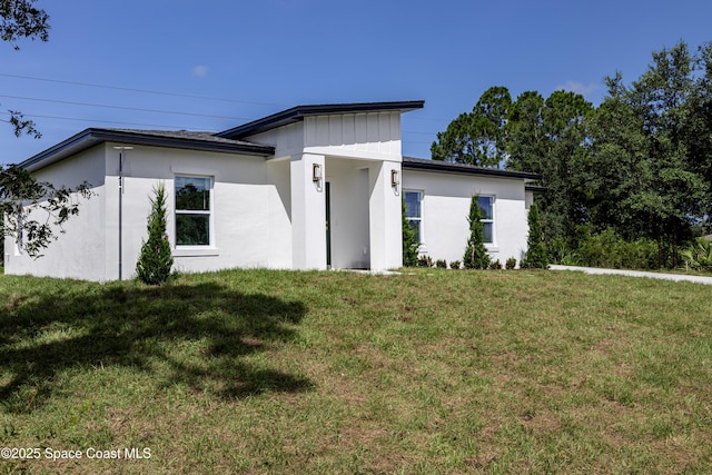 2943 Creech Ave SE, Palm Bay, FL 32909 - view of front of house featuring a front lawn and stucco siding