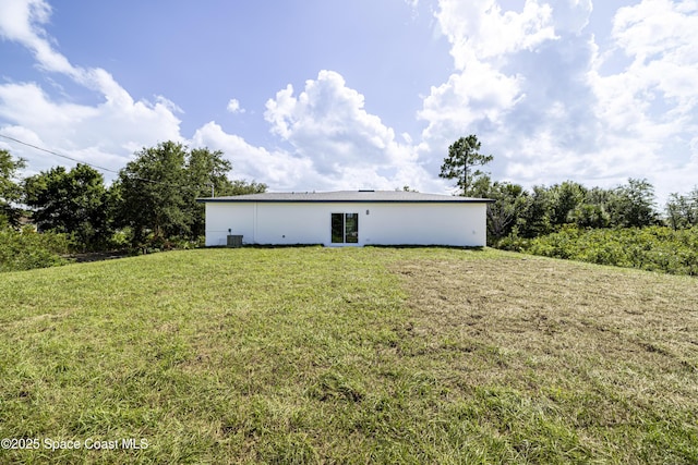 2943 Creech Ave SE, Palm Bay, FL 32909 - rear view of property featuring a lawn