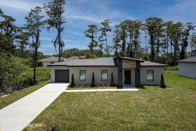 1326 Sagbloom St SE, Palm Bay, FL 32909 - view of front of property featuring an attached garage, driveway, a front yard, and stucco siding