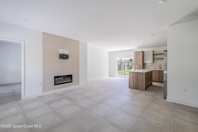 1326 Sagbloom St SE, Palm Bay, FL 32909 - unfurnished living room featuring baseboards and a fireplace