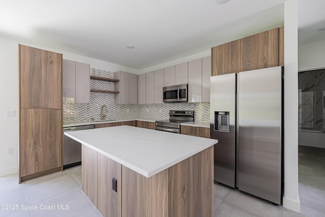 1326 Sagbloom St SE, Palm Bay, FL 32909 - kitchen with stainless steel appliances, modern cabinets, a center island, decorative backsplash, and open shelves