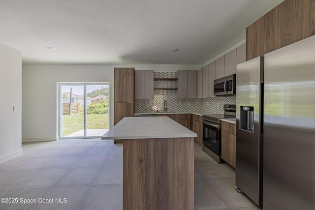 1326 Sagbloom St SE, Palm Bay, FL 32909 - kitchen with stainless steel appliances, open shelves, modern cabinets, tasteful backsplash, and a textured ceiling