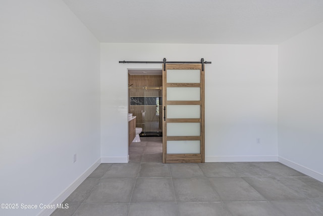 1326 Sagbloom St SE, Palm Bay, FL 32909 - unfurnished room featuring baseboards and a barn door