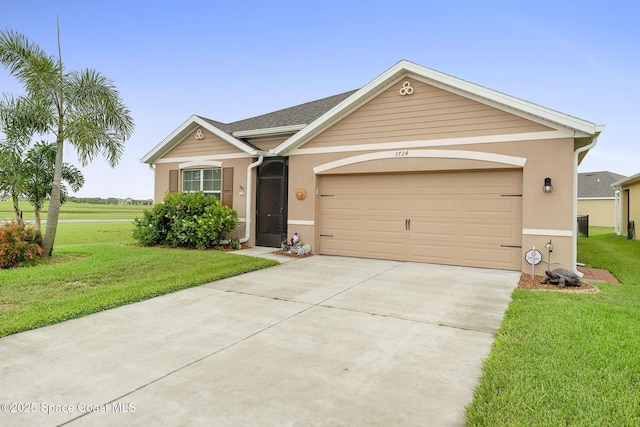 3724 Sandhill Crane Cir, Mims, FL 32754 - view of front of property featuring a front yard, driveway, and stucco siding