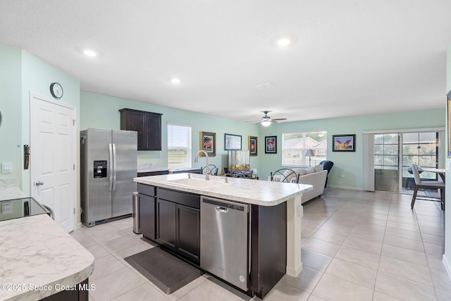 3724 Sandhill Crane Cir, Mims, FL 32754 - kitchen featuring appliances with stainless steel finishes, light countertops, a ceiling fan, light tile patterned floors, and an island with sink