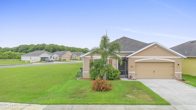 3724 Sandhill Crane Cir, Mims, FL 32754 - view of front of house with a front lawn, concrete driveway, stucco siding, and an attached garage