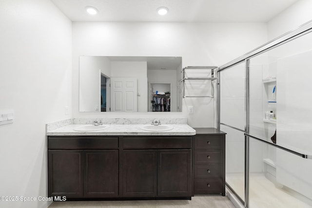 3724 Sandhill Crane Cir, Mims, FL 32754 - full bathroom featuring a stall shower, double vanity, and a walk in closet
