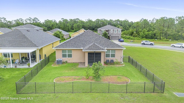 3724 Sandhill Crane Cir, Mims, FL 32754 - back of house featuring stucco siding, roof with shingles, a fenced backyard, and a patio area