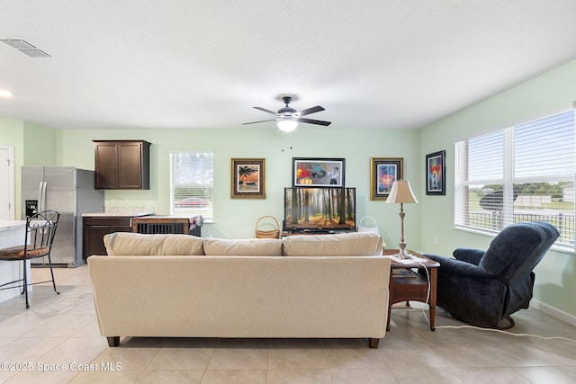 3724 Sandhill Crane Cir, Mims, FL 32754 - living area featuring healthy amount of natural light, a ceiling fan, and light tile patterned flooring