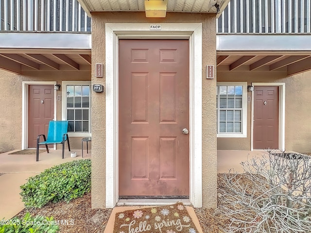 1870 Long Iron Dr Unit 1225, Rockledge, FL 32955 - doorway to property with stucco siding and a balcony