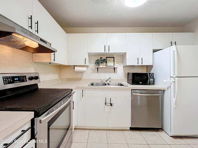 1870 Long Iron Dr Unit 1225, Rockledge, FL 32955 - kitchen with appliances with stainless steel finishes, under cabinet range hood, light countertops, backsplash, and white cabinets