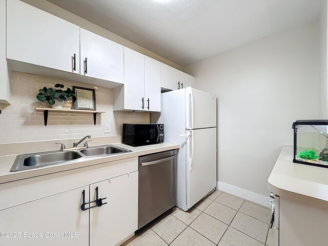1870 Long Iron Dr Unit 1225, Rockledge, FL 32955 - kitchen featuring dishwasher, black microwave, freestanding refrigerator, tasteful backsplash, and light countertops