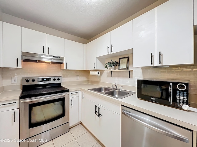 1870 Long Iron Dr Unit 1225, Rockledge, FL 32955 - kitchen featuring appliances with stainless steel finishes, under cabinet range hood, light countertops, white cabinets, and a textured ceiling