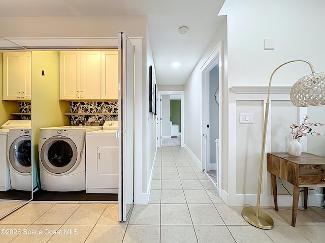1870 Long Iron Dr Unit 1225, Rockledge, FL 32955 - laundry area with cabinet space, washer and dryer, and light tile patterned flooring