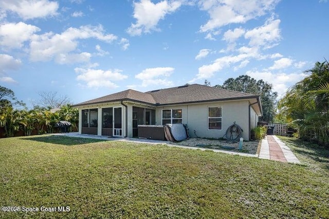 793 Ontario St NW, Palm Bay, FL 32907 - rear view of property with a sunroom, a lawn, and stucco siding
