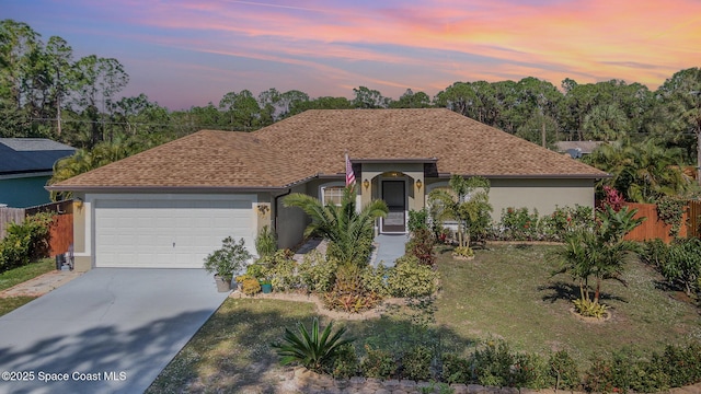 793 Ontario St NW, Palm Bay, FL 32907 - view of front of home featuring stucco siding, an attached garage, concrete driveway, and roof with shingles