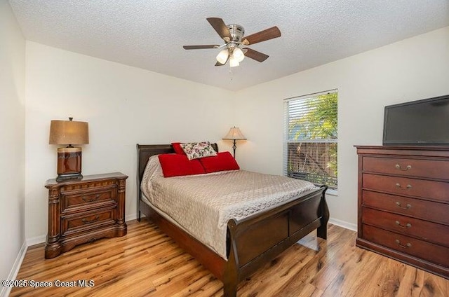 793 Ontario St NW, Palm Bay, FL 32907 - bedroom with light wood-style flooring, a textured ceiling, and a ceiling fan
