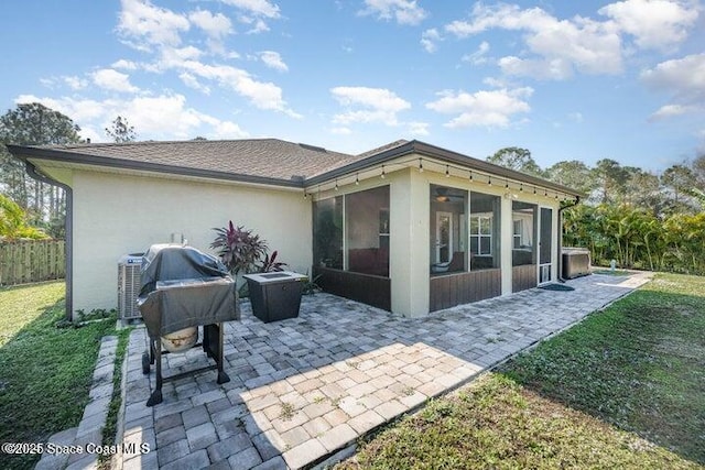 793 Ontario St NW, Palm Bay, FL 32907 - rear view of property with a sunroom, a patio area, and stucco siding